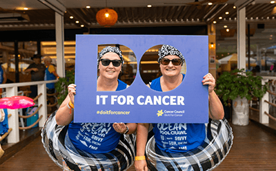 2 women holding the DO it for cancer sign